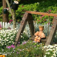 Decorative swing in the design of the garden