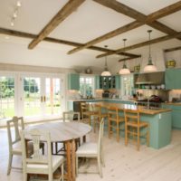 Kitchen furniture with mint facades in the interior of the living-dining room