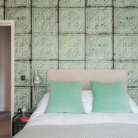 White bedspread and mint pillows in the interior of the bedroom