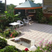 Collapsible gazebo in the corner of a private courtyard