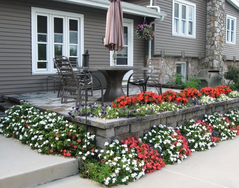 Blooming flowerbed on the outdoor terrace of a country house