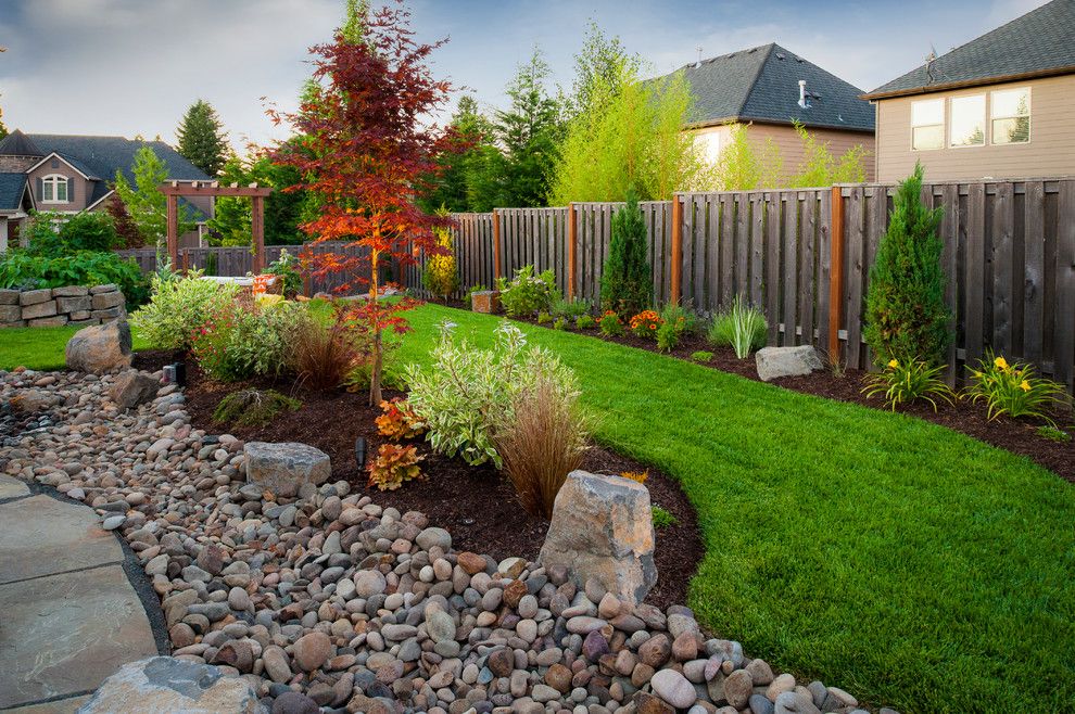 Narrow lawn ribbon and natural stone in a private garden