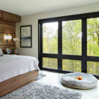 View from the bedroom to the nature through a panoramic window