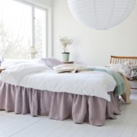 White bedroom with lavender bedspread