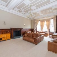 Spacious living room of a private house with stucco molding on the ceiling