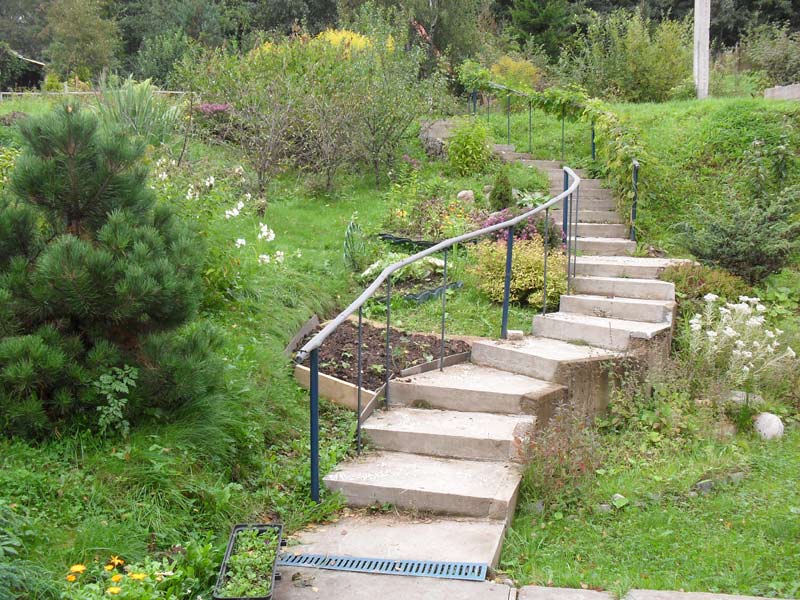 Staircase with railing on the slope of a suburban area