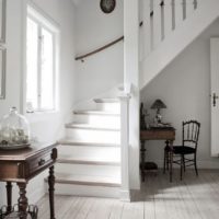 White staircase in the entrance hall of a residential building