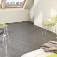 Gray floor in a room with slanted windows