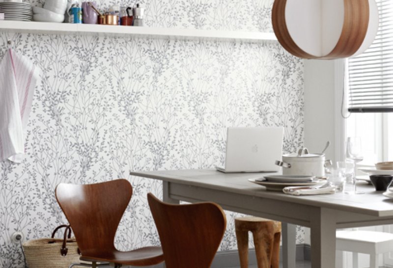 Dining table next to duplex wallpaper