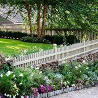 Flower bed along a wooden fence