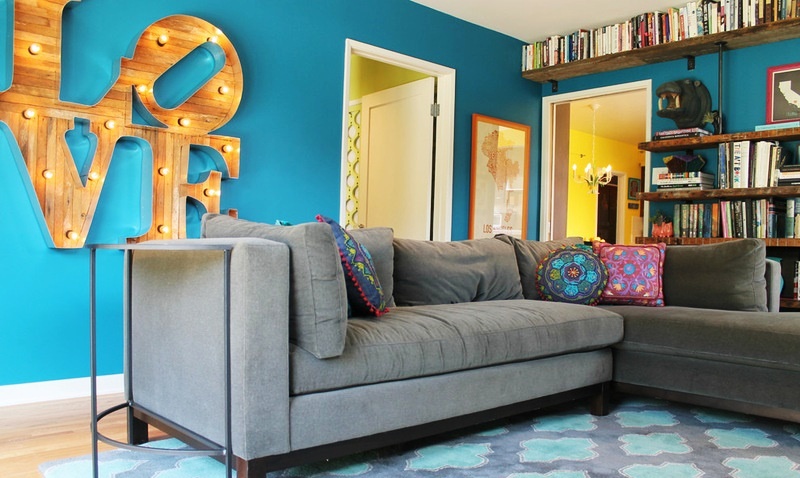 Wooden letters with bulbs in the interior of a living room