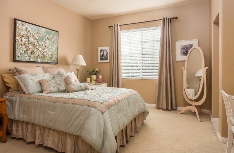 Oval mirror in the corner of the bedroom