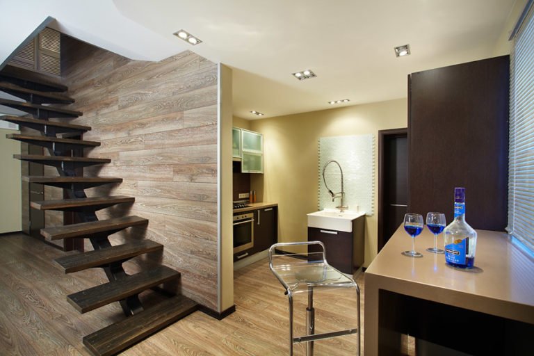 Wall finishes along the staircase with gray laminate panels