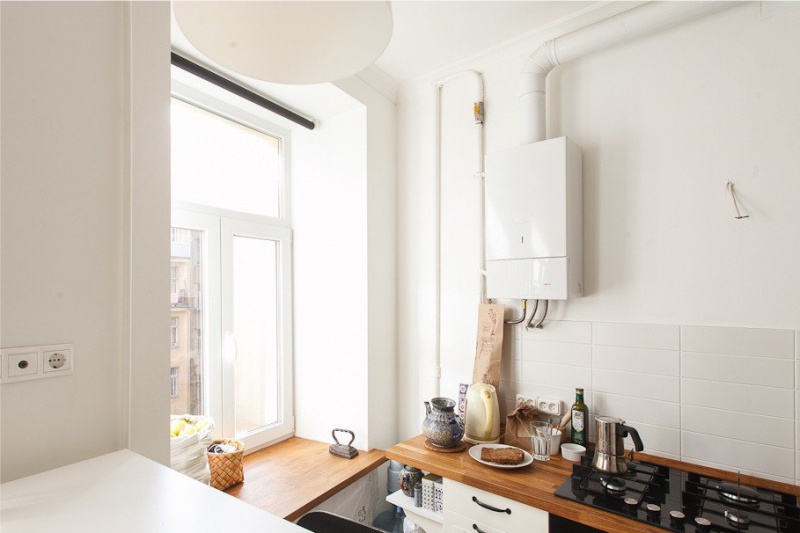 White gas boiler on the wall of a modern kitchen