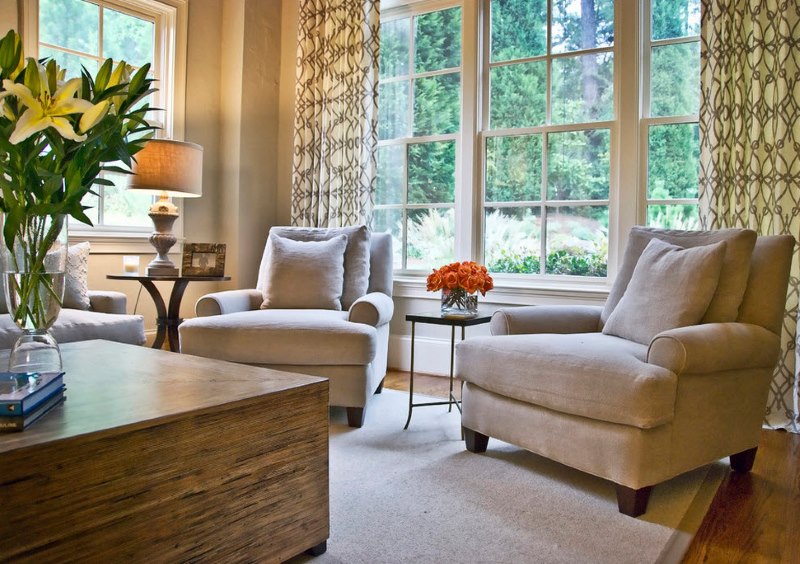 Beige upholstered armchairs in a neoclassical living room