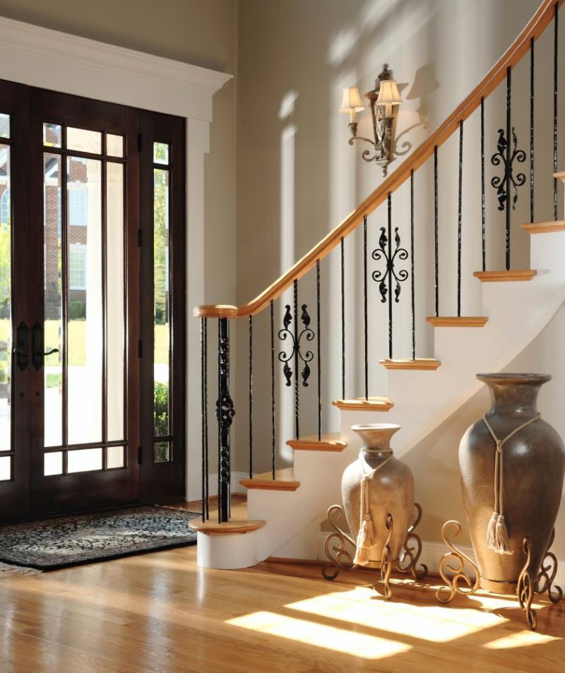 Vases on forged stands in the interior of the hallway of a private house