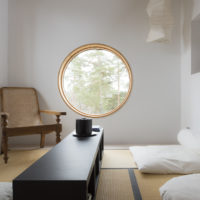 Round window in the walls of the living room of a country house