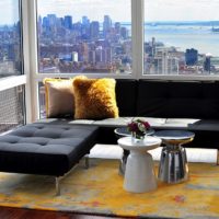 Black sofa in front of a panoramic window