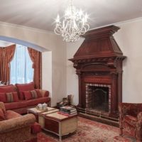 Dark shades of red in the living room with fireplace.