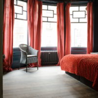 Red curtains in the gray bedroom