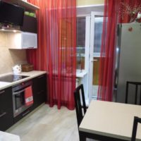 Red curtains on a window with a balcony door