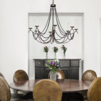 Black chandelier over a wooden table