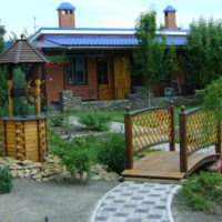 Garden composition of a bridge and a decorative well