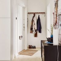 Black furniture in a white hallway