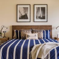 Striped textile on a bed in a marine style.