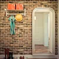 Wall in the hallway with wallpaper under a brick