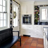 White kitchen in the living room of a country house