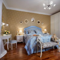 Blue bedding in bedroom with wooden floor.