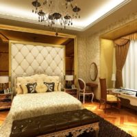 Black chandelier in the bedroom with gold decor