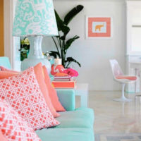 Pink pillows on a mint sofa