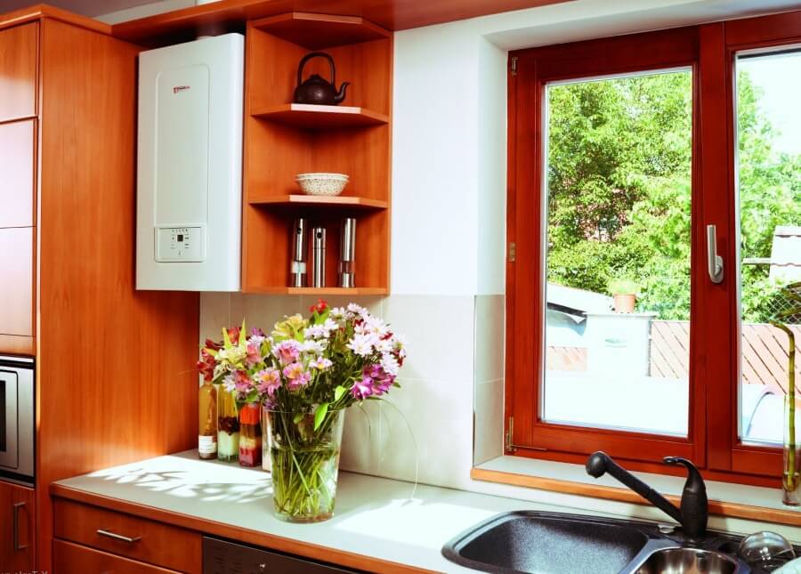 Interior of the kitchen of a private house with a gas boiler near the window