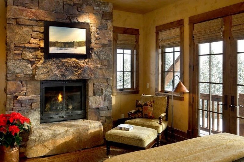 Stone and wood in the decoration of a room in a country house