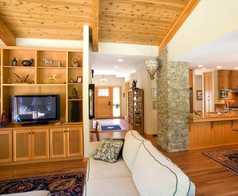 Giskartonny column with stone trim in the interior of the kitchen-living room