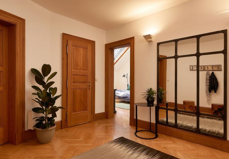 Entrance hall of a private house with brown floor and wooden doors