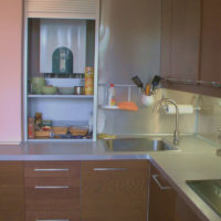 Shelves for kitchen utensils inside a cabinet with a gas boiler