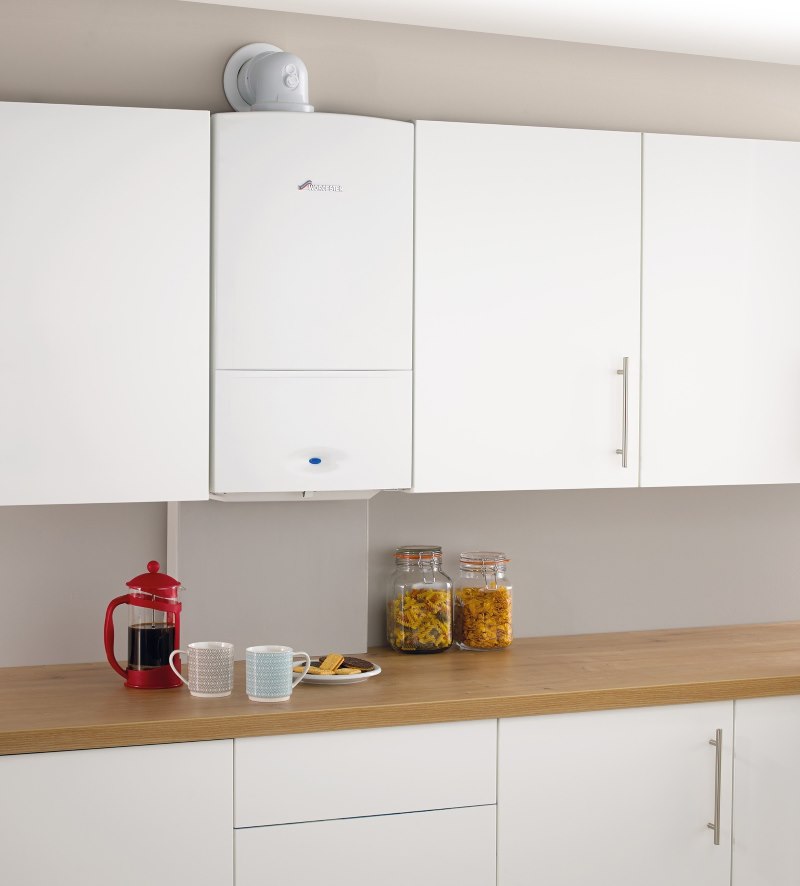 Kitchen interior with white gas boiler between the kitchen cabinets