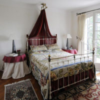 Metal bed in the bedroom of a country house