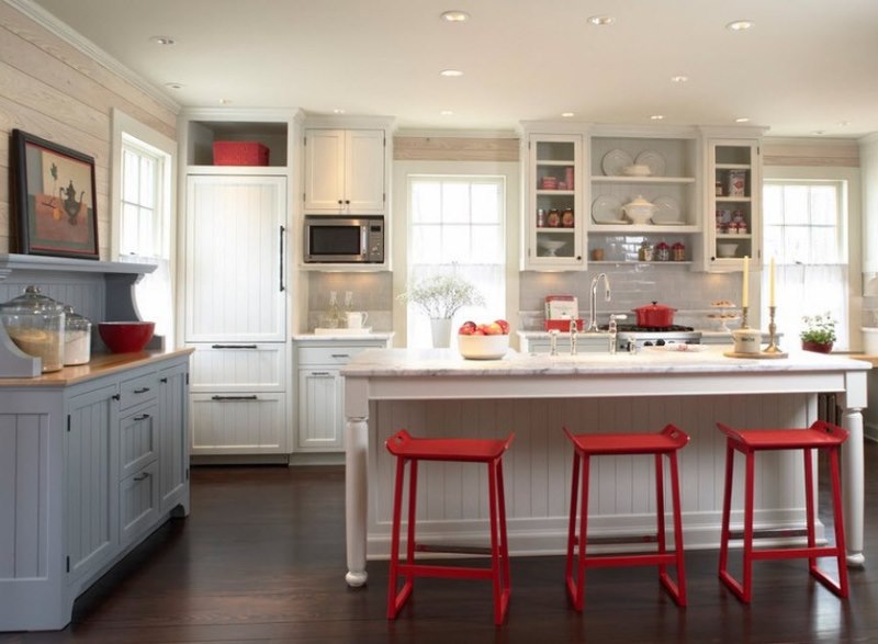 Red chairs on a background of white furniture in the dining area