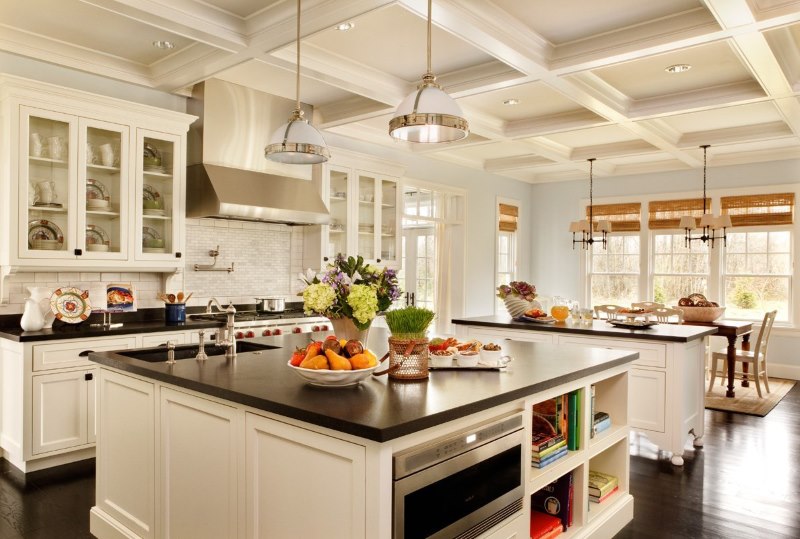 Design of a bright kitchen of a rural house with embossed beams on the ceiling