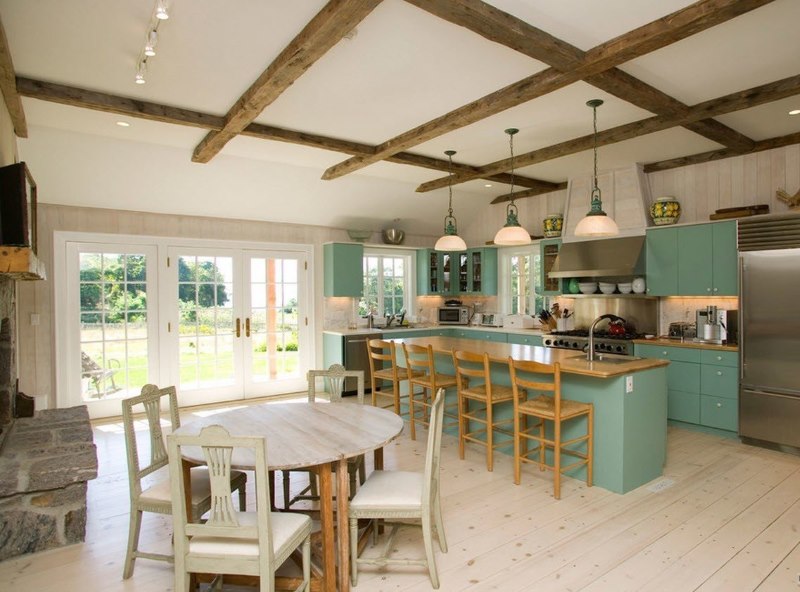 Wooden beams on the white ceiling of a private house kitchen