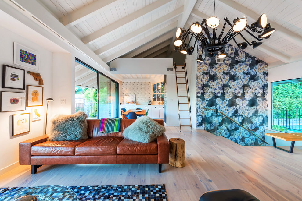 Black chandelier in the form of a spider in the interior of the living room of a country house