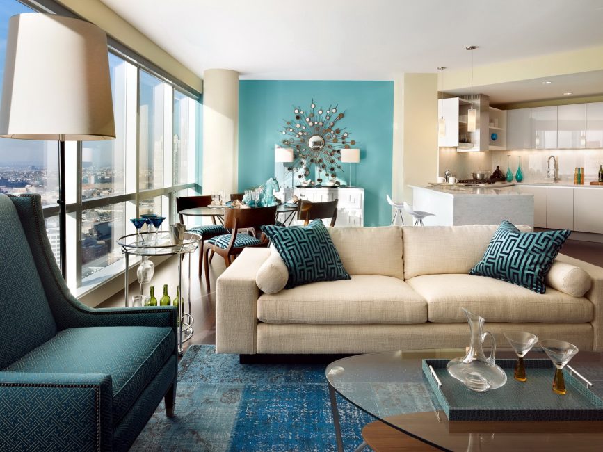 Living room interior with mint walls and a beige sofa.