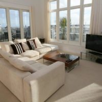 Living room with large windows in bright colors.