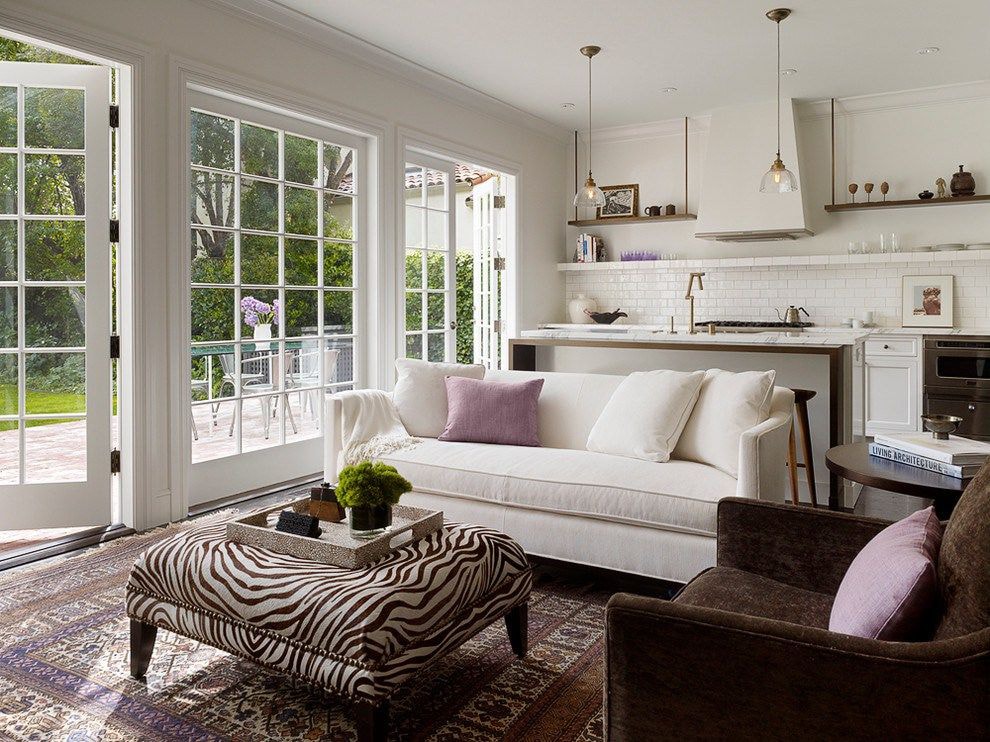 Interior of a kitchen-living room of a country house with access to the garden