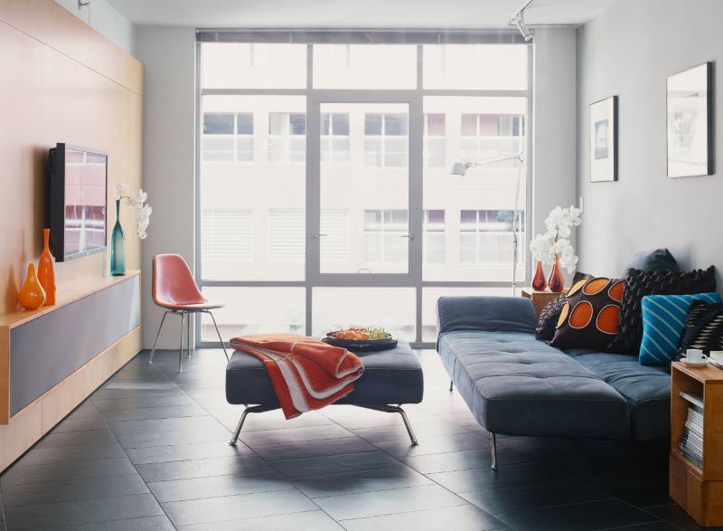 Panoramic windows in the living room with a folding sofa