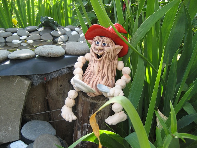 Water figure on the shore of an artificial reservoir in a summer cottage